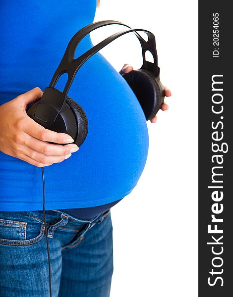 Pregnant woman with headphones isolated on white