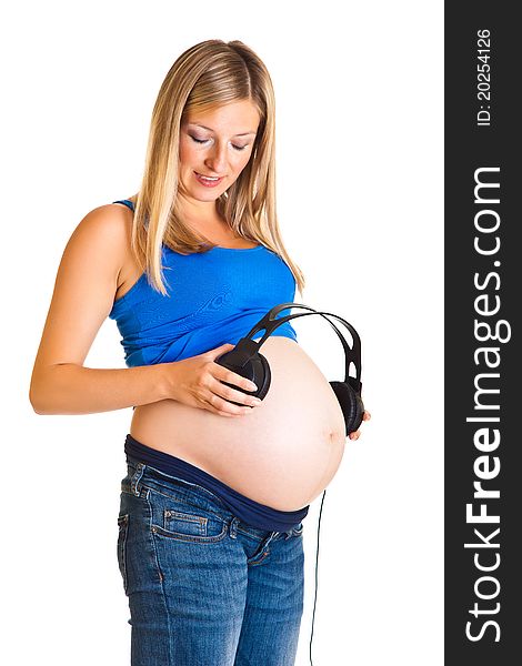 Pregnant woman with headphones isolated on white