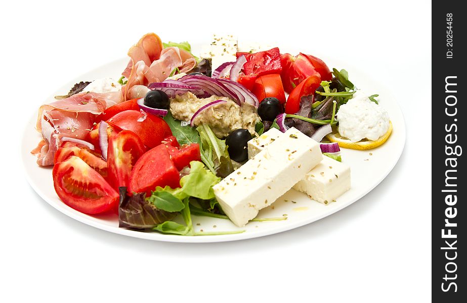 Appetizer of mixed meat, vegetables and cheese (shallow  DOF, focus in the middle)