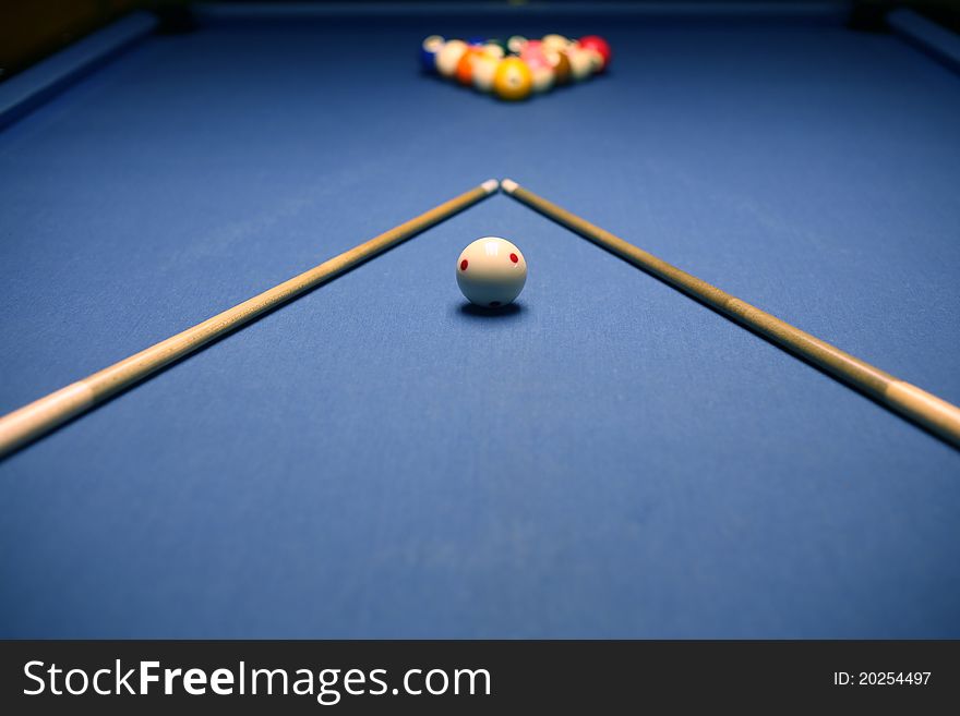 Billiard blue table with balls and cues in beginning position. Billiard blue table with balls and cues in beginning position.