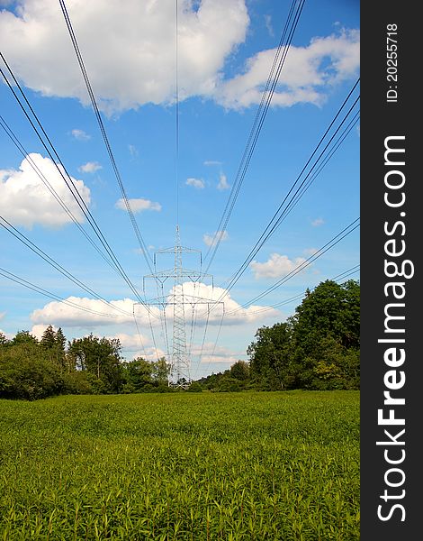 Pylon in front of blue sky, clouds and green landscape. Pylon in front of blue sky, clouds and green landscape
