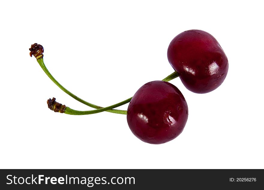 Two red cherries on a white background