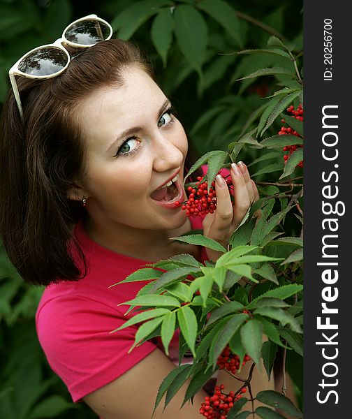 The cheerful girl with red berries