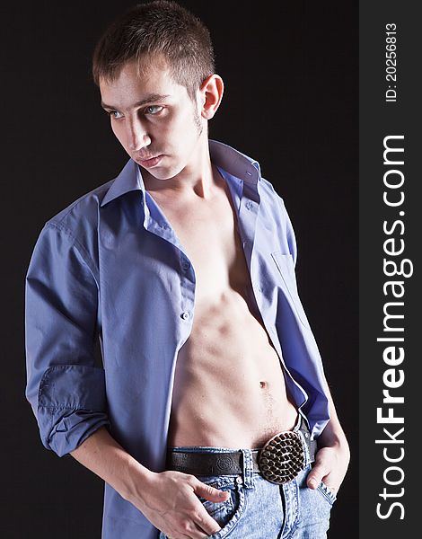 Fashion Shot of a macho Man. A trendy European man dressed in contemporary cloth. He is now a professional model.