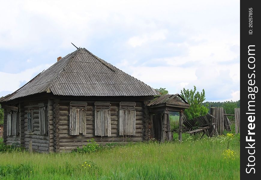 Abandoned wooden house with boarded up windows in the Russian countryside. Abandoned wooden house with boarded up windows in the Russian countryside.