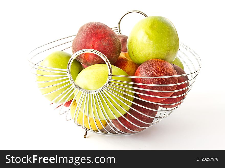 Apples and peaches in a vase on a white background