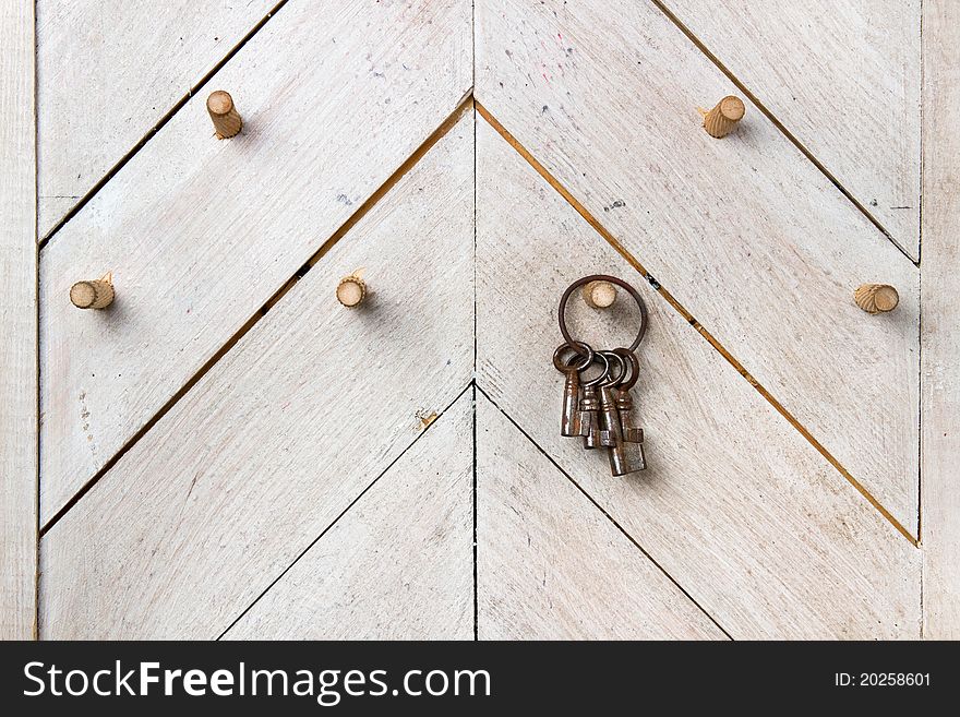 Set of old vintage keys hanging on  hook clogged at wooden wall. Set of old vintage keys hanging on  hook clogged at wooden wall