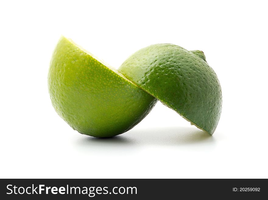 Lime halves lying one above the other, isolated on white