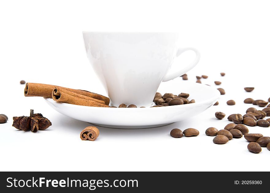 Cup of coffee and cinnamon bark on a white background. Cup of coffee and cinnamon bark on a white background