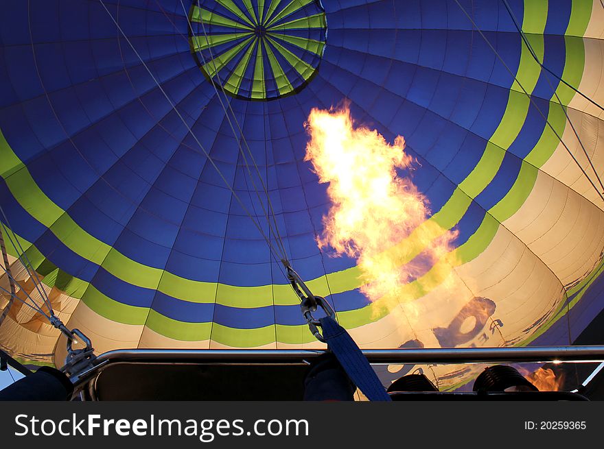 Hot air balloon with bright burning gas flame