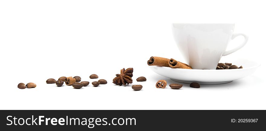 Cup of coffee and  cinnamon bark on a white background