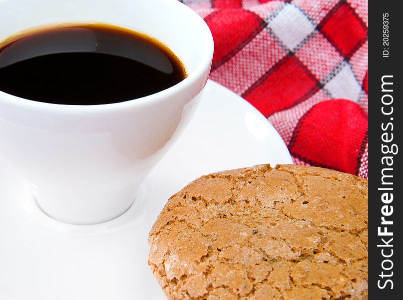 Cup of tea and cookie on a red tablecloth
