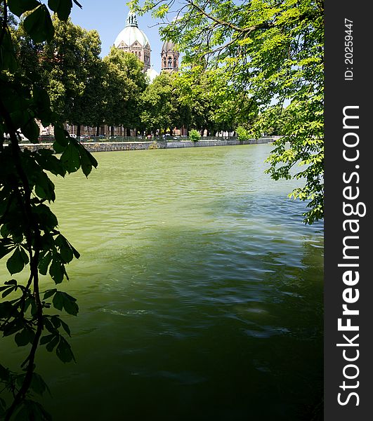 A shady place along the Isar River in Munich with the Church of St. Luke in the back. A shady place along the Isar River in Munich with the Church of St. Luke in the back.