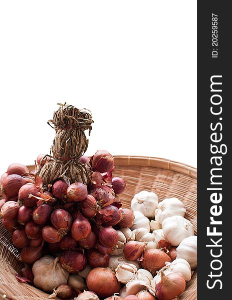 Red onions and garlic in basket isolated background