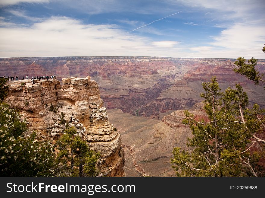 Tourists gather at an overlook at the Grand Canyon. Tourists gather at an overlook at the Grand Canyon