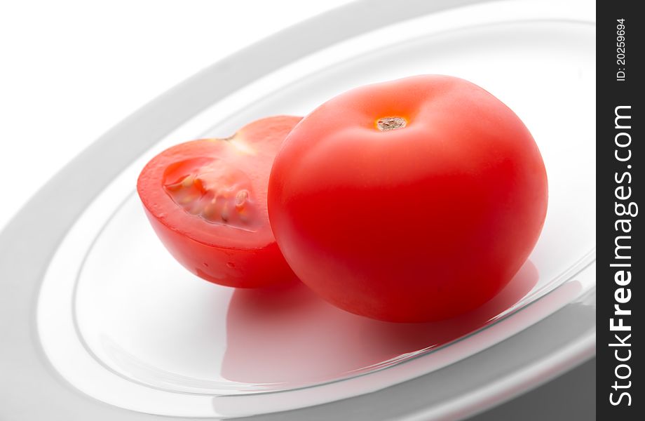 Ripe tomatoes on a white plate