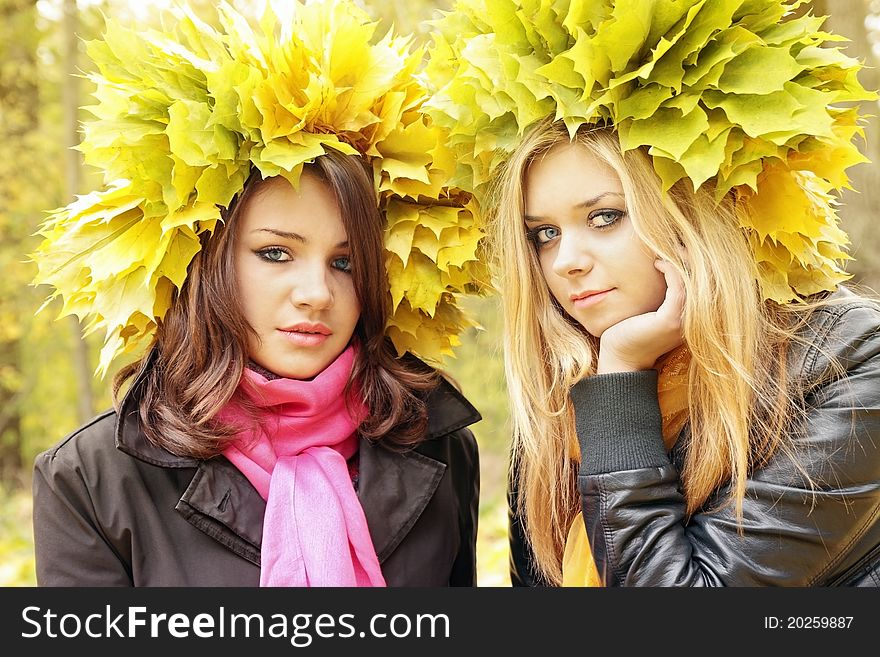 Two beautiful girls in the wreath from leaves. Two beautiful girls in the wreath from leaves