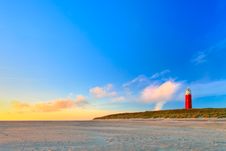 Seaside With Sand Dunes And Lighthouse At Sunset Royalty Free Stock Photo