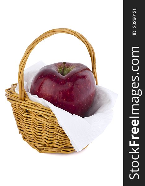 Red apple in a small wooden basket isolated on white. Red apple in a small wooden basket isolated on white.