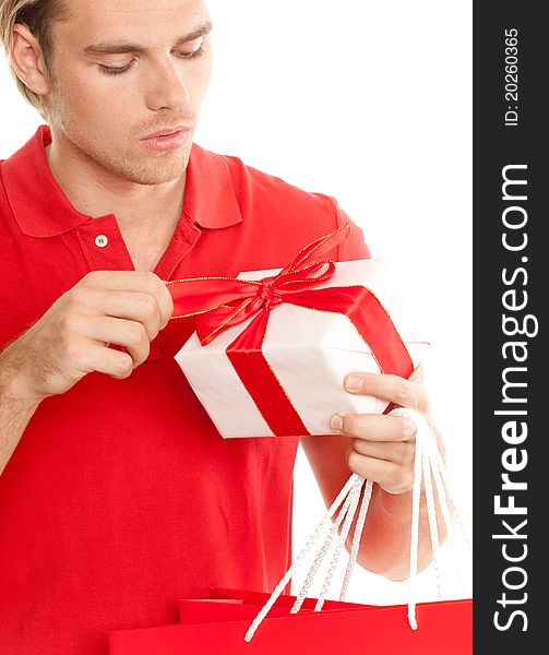 Young blond attractive man open a gift. Young blond attractive man open a gift