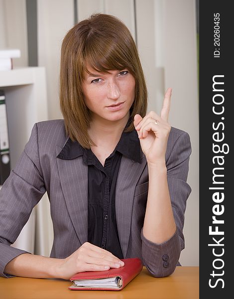 Business woman with diary pointing finger
