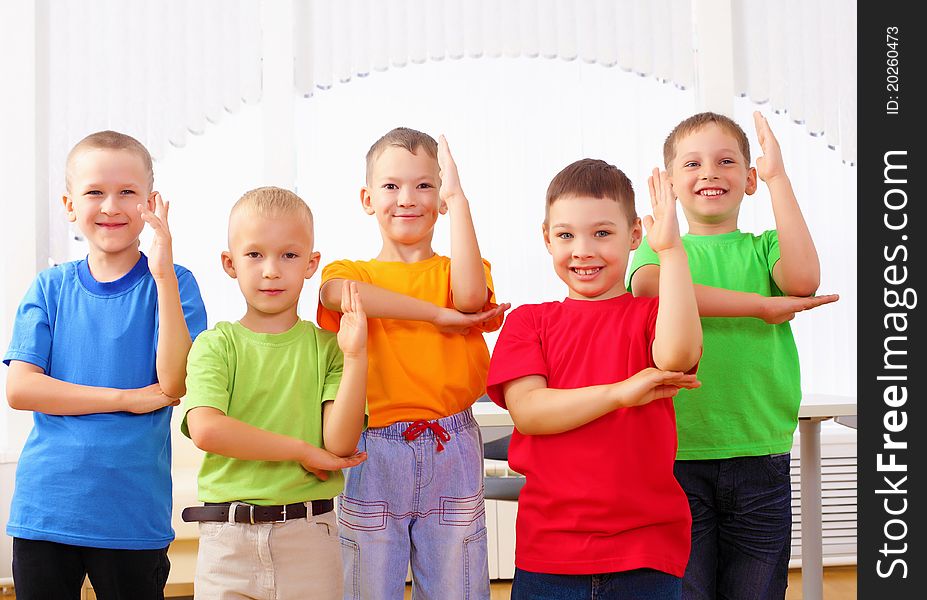 Group classmates standing in a row in the classroom