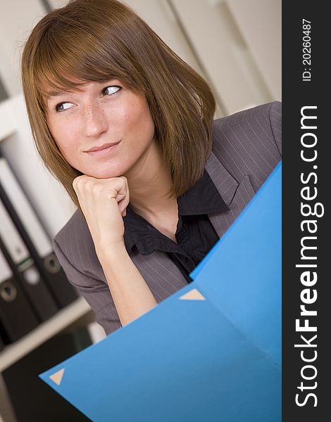 Business woman holding application file and smiling. Business woman holding application file and smiling