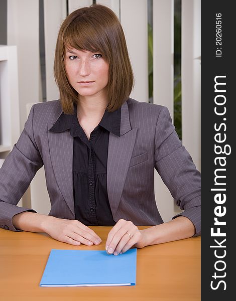 Woman with application file in office