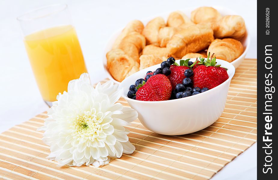 Early breakfast. Strawberries, cream and juice. The symbol of healthy lifestyles.