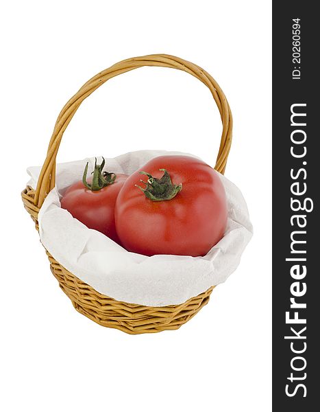 Tomato in a wooden basket, isolated on white. Tomato in a wooden basket, isolated on white.