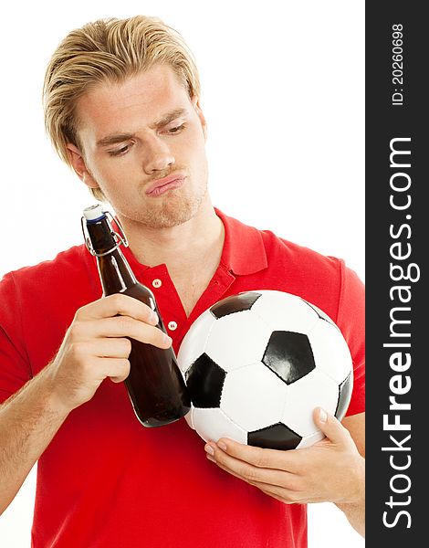 Blond man is looking to his beer and ball