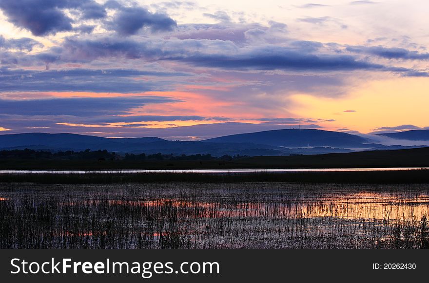 The landscape of sunrise of grassland by the river. The landscape of sunrise of grassland by the river