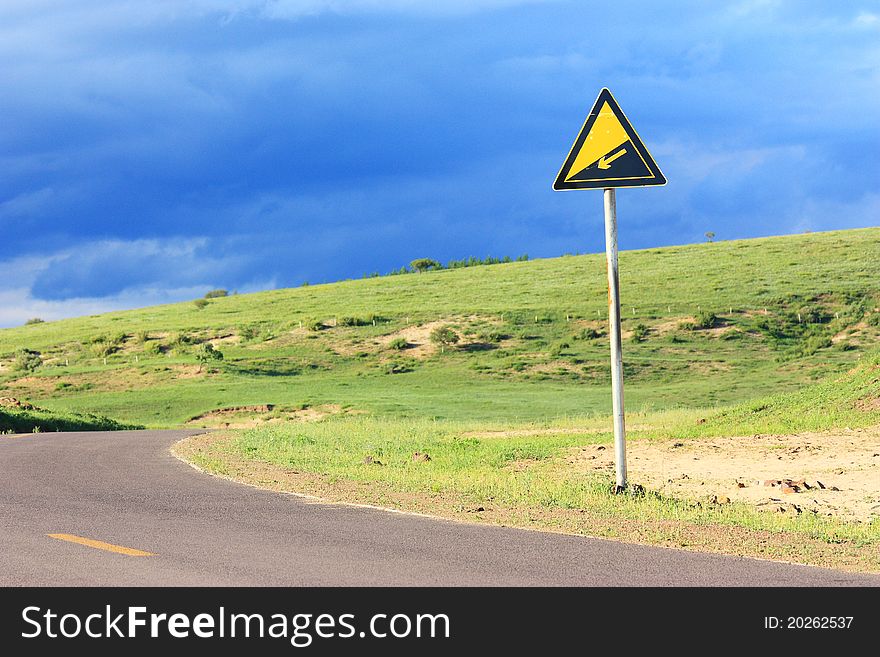 Landscape  of  road with signpost in the grassland