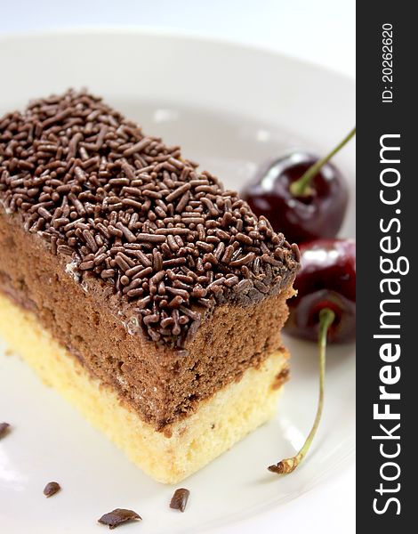 A slice of chocolate cake on white plate