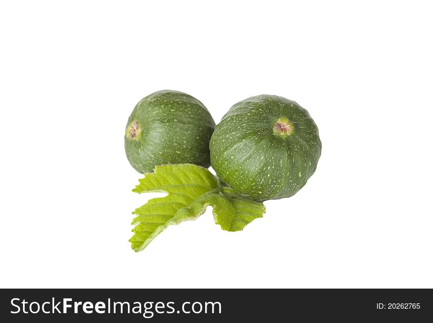 Two small figs and a leaf against a white background