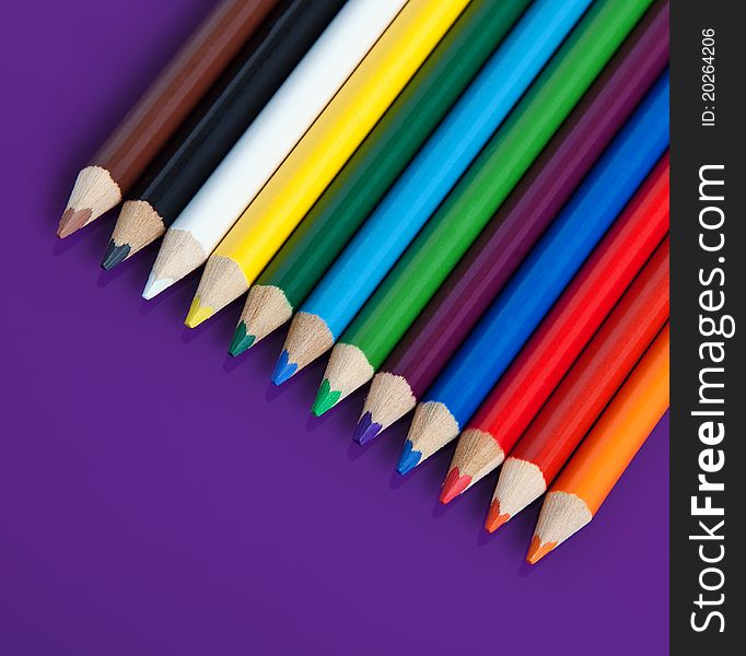 Color pencils crayons on purple background