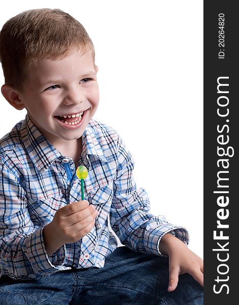 A little boy with candy on a white background