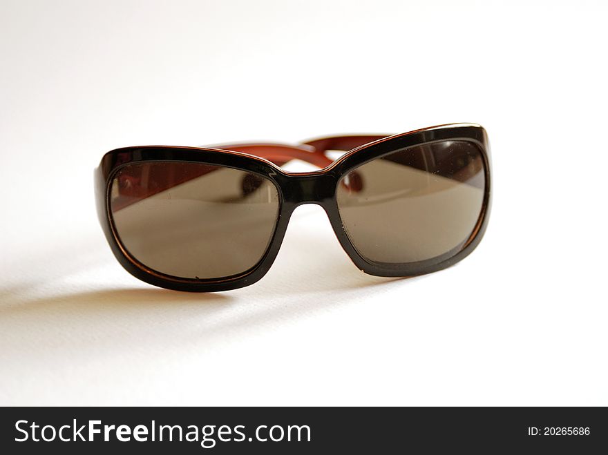 Brown style sunglasses on a white background. Brown style sunglasses on a white background