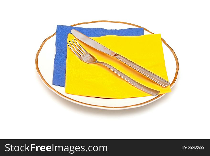 Knife fork napkin and plate isolated on white