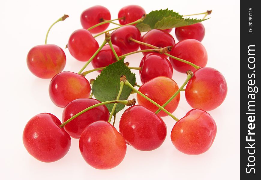 Group of red cherries with stalks and leaves