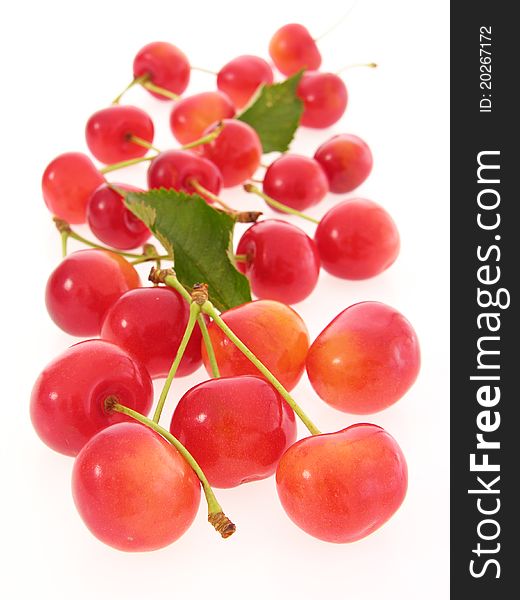 Group of red cherries with stalks and leaves