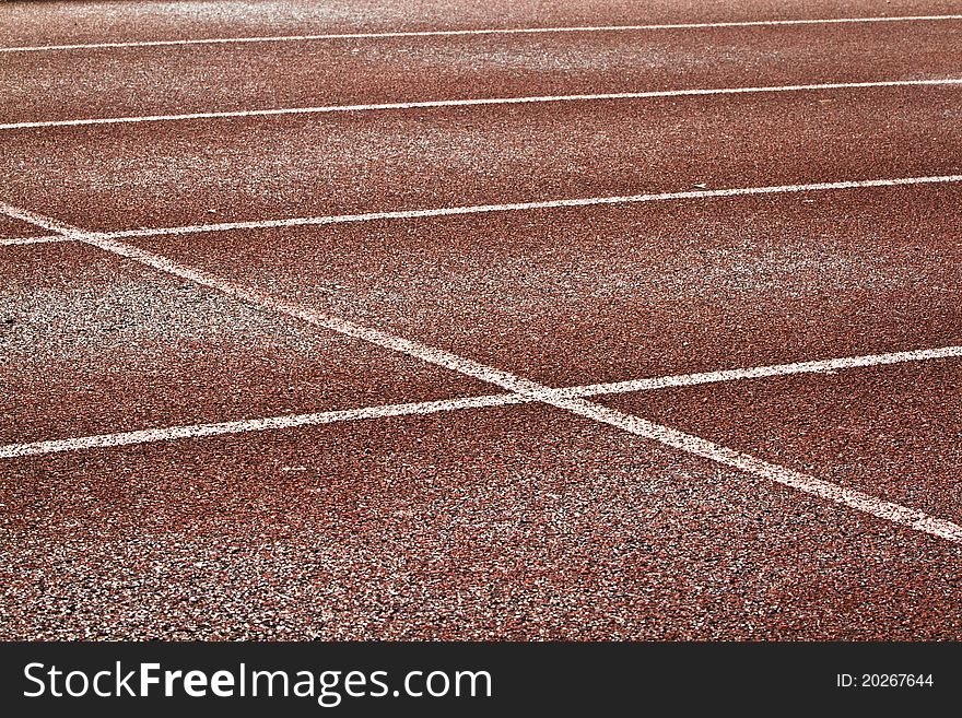 Empty running track, visible white lines