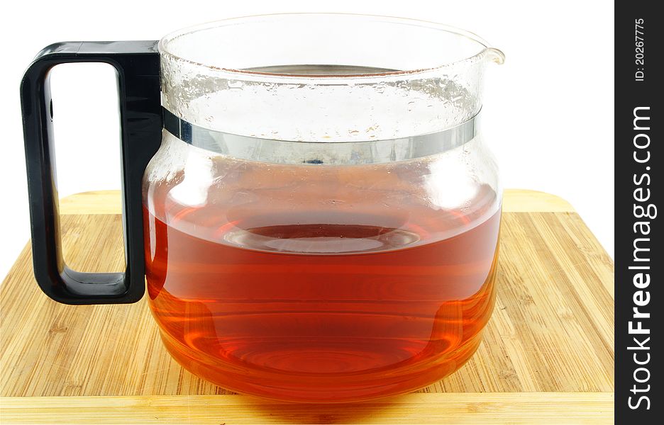 Glass tea pot closeup over white