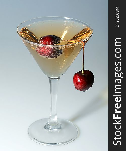 Cherry in a glass with champagne