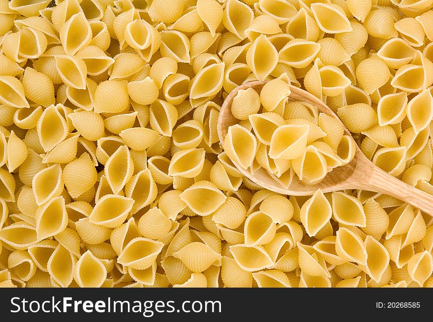 Pasta and wooden spoon as background