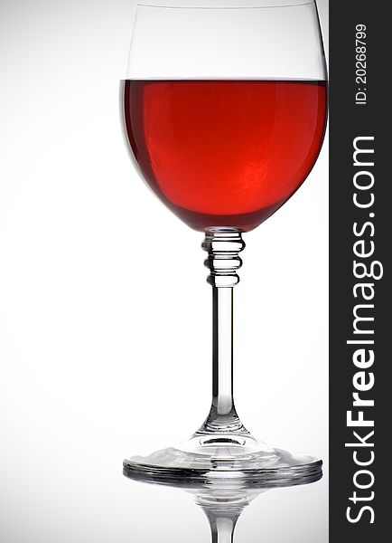 Glass of red wine on white