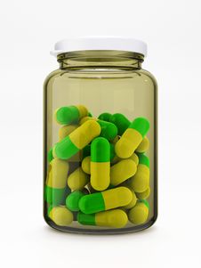 Green-yellow Pills In Medical Bottle On White Stock Photography