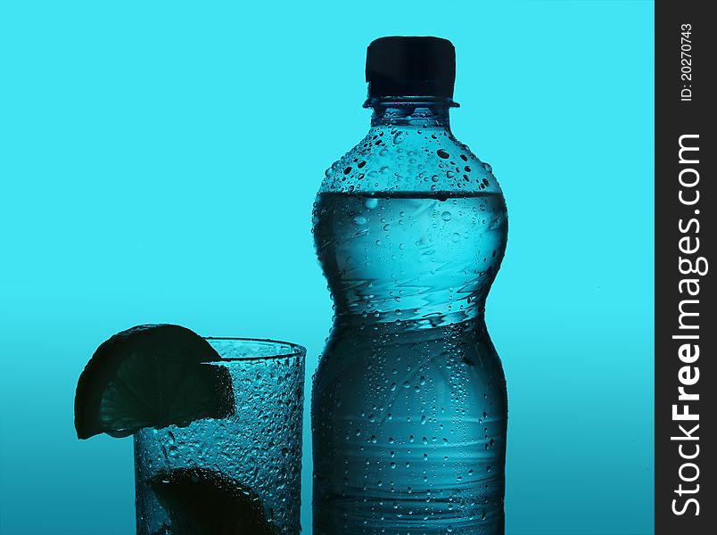 Silhouette of bottle and glass over blue background