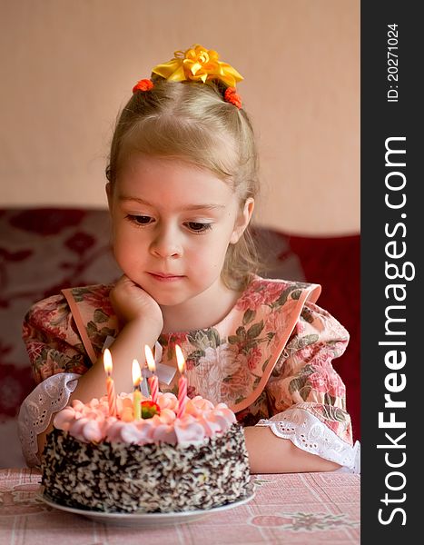 The little girl make a wish before you blow out the candles. The little girl make a wish before you blow out the candles