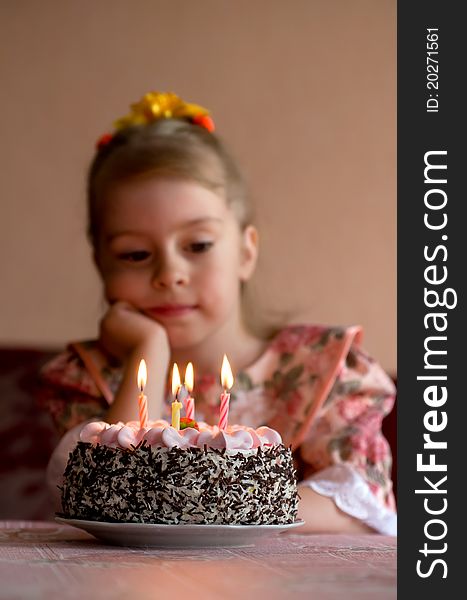 The little girl make a wish before you blow out the candles. The little girl make a wish before you blow out the candles